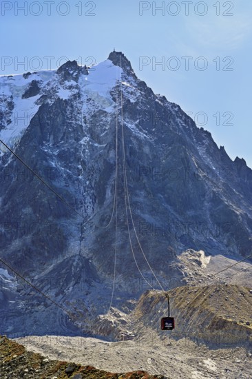 View of the arriving cable car from the Plan de l'Aiguille middle station, in the back the mountain station of the Aiguille du Midi, Chamonix-Mont-Blanc, Haute-Savoie, France