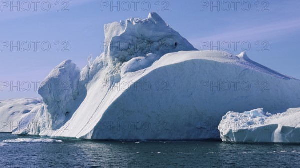 Boat excursion near icebergs of Kangia Fjord and Sermeq Kujalleq glacier in Ilulissat, Greenland