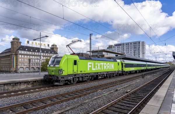 Flixtrain train on track 2 in Essen main station, view of the city center, Handelshof building with Essen lettering, North Rhine-Westphalia, Germany