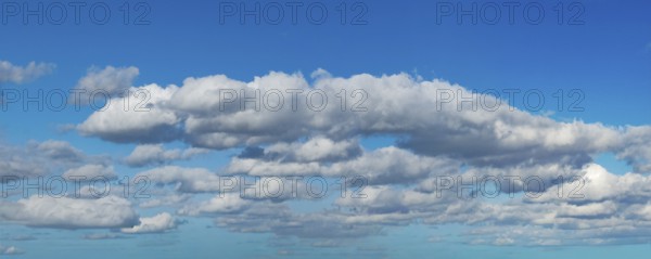 White clouds above Altocumulus in the background below Cumulus cloudy against blue cloudy sky, international