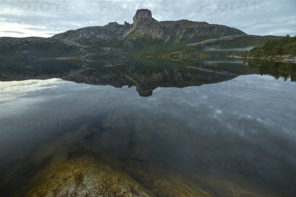 Morning dream over the quiet Steigtindvatnet near Bodø. The mountain is reflected in the lake
