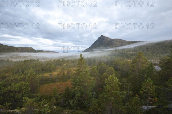 Magical morning fog on Steigtindvatnet in front of the majestic Litltind in Norway near Bodø