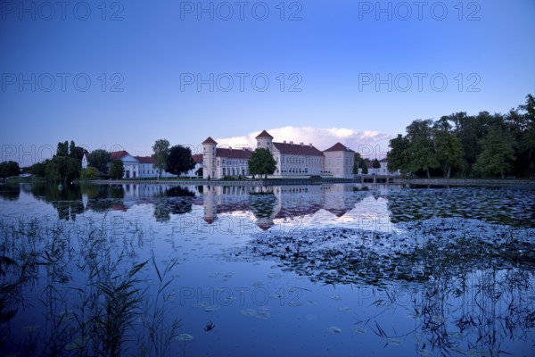 Rheinsberg Castle, lakeside with Lake Grienerick at night, prime example of Friederician Rococo, Brandenburg, Germany
