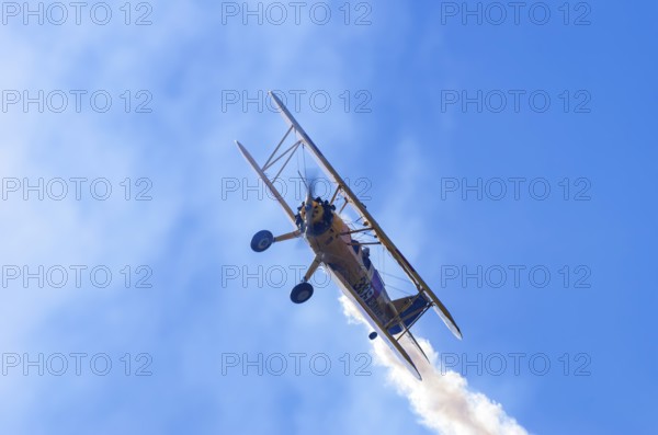 A Boeing PT-17 Stearman biplane, also Boeing Stearman Model 75, with the inscription 399 USNAVY N67193 during a flight demonstration as part of an air show on Rossfeld in Metzingen-Glems, Baden-Württemberg, Germany, for editorial use only