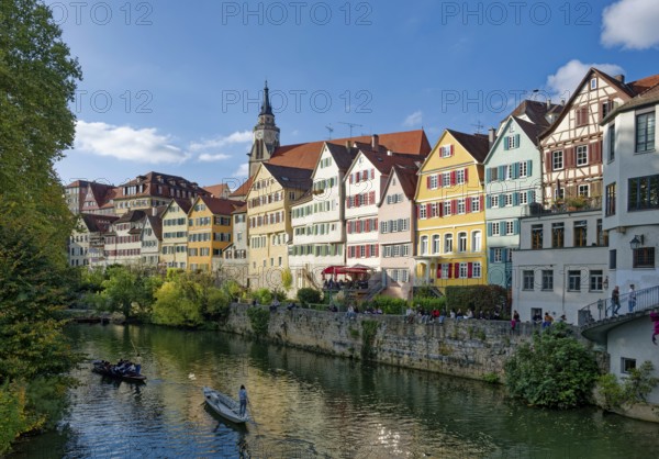Historic houses on the Neckar front, the Neckar river with poking and water reflection, old town of Tübingen, Baden-Württemberg, Germany