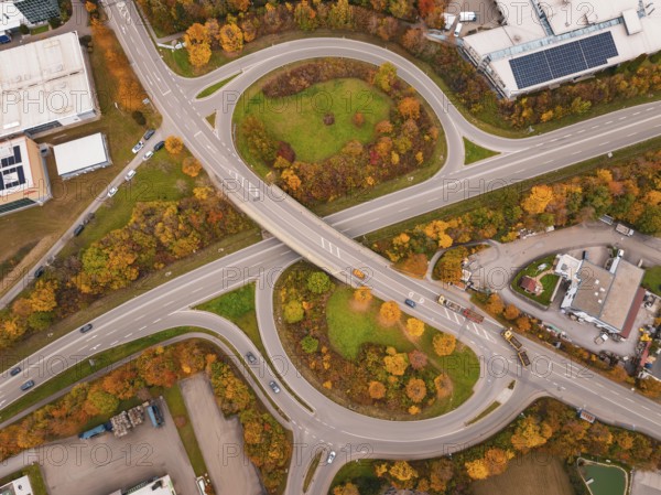 Modern road network with roundabout and autumn trees from an aerial perspective, Dornstetten, Freudenstadt district, Germany