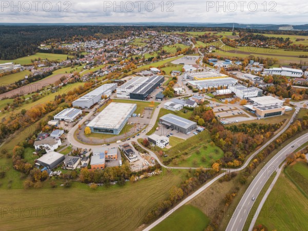 Extensive industrial area with autumn trees and buildings seen from an aerial perspective, Dornstetten, Freudenstadt district, Germany