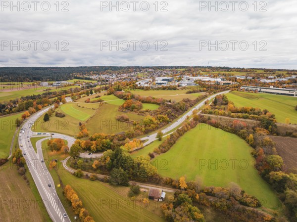Wide landscape with winding roads, meadows and autumn atmosphere under cloudy sky, Dornstetten, Freudenstadt district, Germany