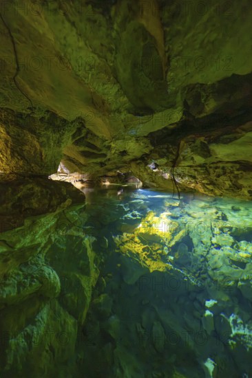 Scenario in a cave with crystal clear water and impressive rock walls, Wimsener Höhle, Hayingen, Germany