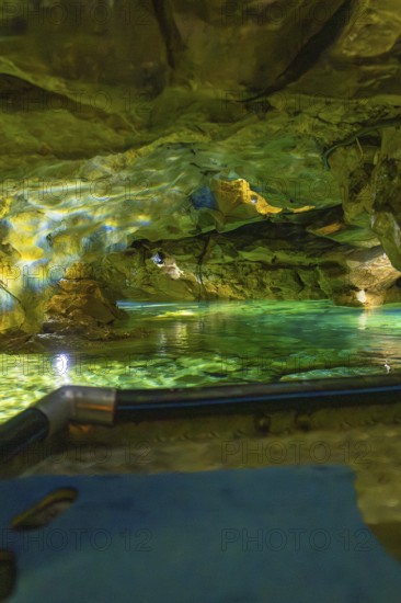 Underground scenario in a cave with shimmering green water and dramatic lighting, Wimsener Höhle, Hayingen, Germany