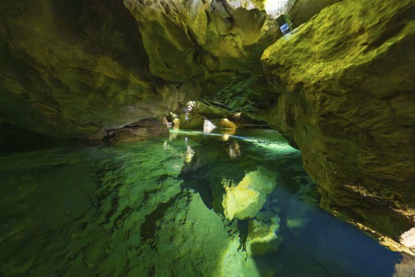 Enchanting cave with glowing water and natural rock structures in the underground, Wimsener Höhle, Hayingen, Germany