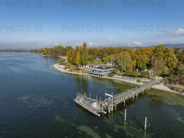 Aerial view of the Mettnau peninsula, surrounded by autumn vegetation, in western Lake Constance with the beach cafe and the pier, Radolfzell, district of Konstanz, Baden-Württemberg, Germany