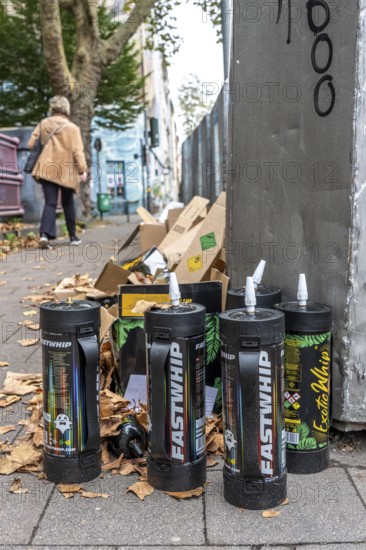 Empty cartridges filled with N2O, nitrous oxide gas, called laughing gas, officially it serves as a propellant to produce whipped cream in appropriate devices, but is often used as an intoxicant, party drug, misused, here mass, illegal disposal in addition to waste paper containers in Düsseldorf, North Rhine-Westphalia, Germany