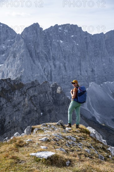 Female hiker on hiking trail, hiking to Gamsjoch, behind Dreizinkenspitze and Laliederer Wand, eastern Karwendel, Tyrol, Austria