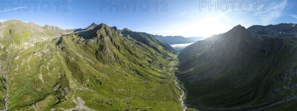 Alpine panorama, aerial view, Lasörlinghütte mountain hut in evening light, mountain landscape with alpine roses, Lasörling Group, Hohe Tauern, East Tyrol, Austria
