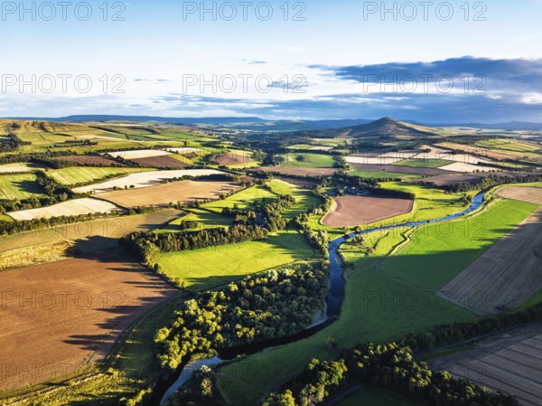 Fields and Farms over River Teviot and Minto Crags from a drone, Roxburghshire, Scottish Borders, Scotland, UK