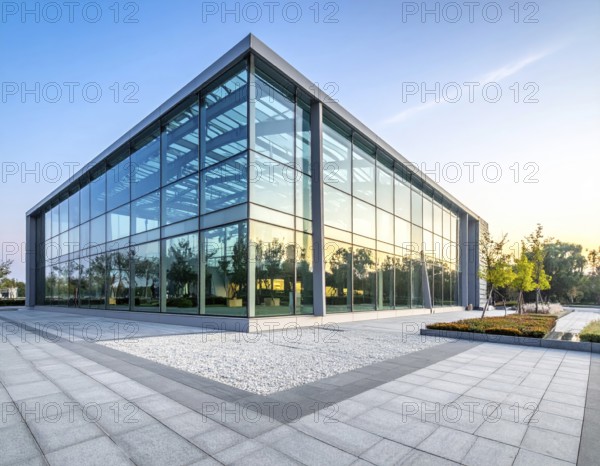 Modern architectural framework with glass and steel structure, glass facade with a greed of steel arrows, blue sky with a soft golden light of a sunrise, AI generated