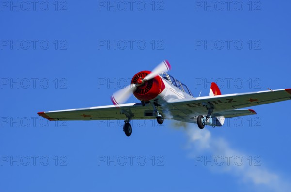 A Jakovlev Jak-52 with registration LY-HLZ during a flight demonstration as part of an air show on Rossfeld in Metzingen-Glems, Baden-Württemberg, Germany, for editorial use only