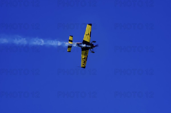 A Votec 351 sport aircraft from the Swiss MSW Aviation AG with registration HB-YMV during a flight demonstration as part of an air show on Rossfeld in Metzingen-Glems, Baden-Württemberg, Germany, for editorial use only