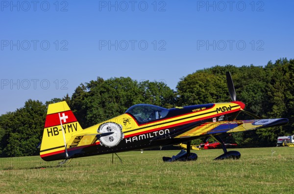 A Votec 351 sport aircraft from Swiss MSW Aviation AG with registration HB-YMV during a flight demonstration as part of an air show on Rossfeld in Metzingen-Glems, Baden-Württemberg, Germany, for editorial use only, digitally reworked