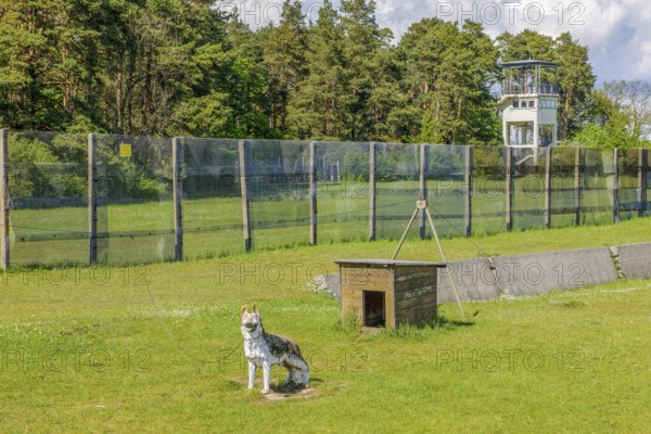 Preserved original GDR border fence with green death strips from the 1970s, in the background US watchtower on the former inner German border with the GDR Eastern Bloc, point Alpha memorial, former zone border, Rasdorf, Hesse, Geisa, Thuringia, Germany