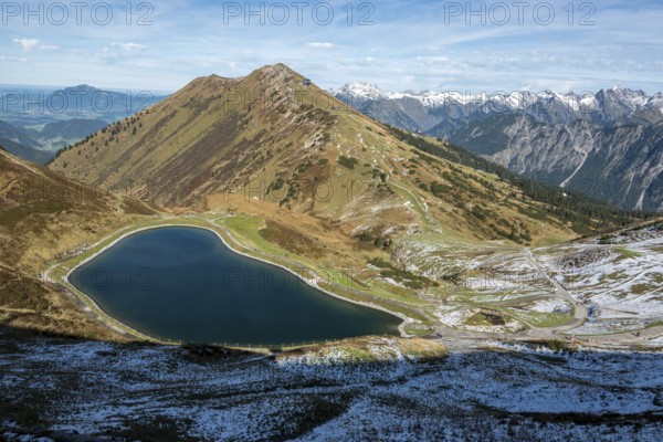Reservoir, Kanzelwand snow-making pond, behind Fellhorn and mountains of the Allgäu Alps, Vorarlberg, Austria