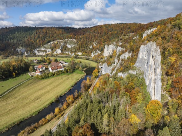 Aerial view of Käppeler Manor with St. George's Basilica near Thiergarten in the Upper Danube Valley, surrounded by autumn vegetation, on the right the raven rocks, climbing rocks, Jura limestone rocks, Sigmaringen district, Baden-Württemberg, Germany