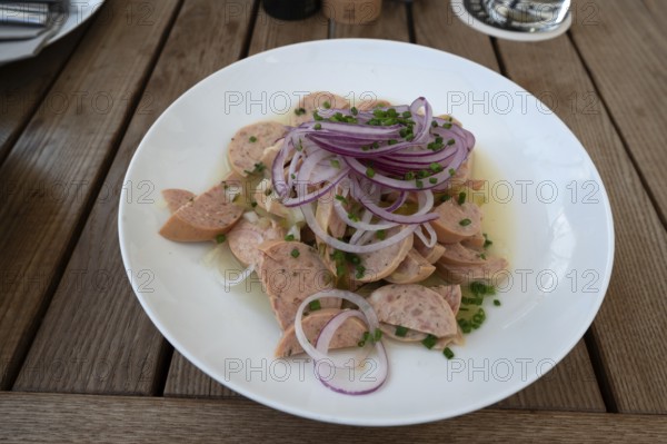 City sausage served with onions in a garden restaurant, Franconia, Bavaria, Germany