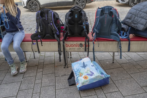 Students waiting for the bus, school bags left on a bench, Bavaria, Germany