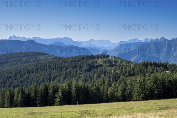 View from Stoisser Alm in Chiemgau of the Berchtesgaden and Chiemgau Alps and the wooded Teisenberg in the foreground, Bavaria, Germany