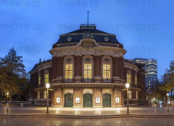 Laeiszhalle, formerly Musikhalle Hamburg, at Johannes Brahms Platz at Blue Hour with light clouds in the background and street lights in the foreground, Hamburg, Germany