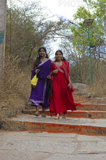 Young Indian woman on the red steps to Chamundi Hill, Mysore or Mysore, Karnataka, India