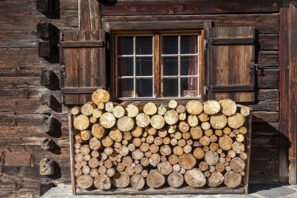 Sawn firewood in front of an old wooden house, Oberallgäu, Allgäu, Bavaria, Germany