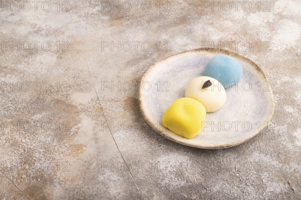 Japanese Mochi Cakes on brown concrete background, side view, copy space