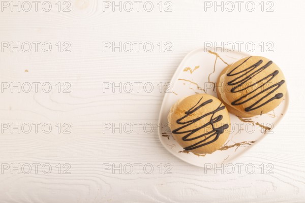 Caramel Cream Cakes on white wooden background, top view, flat lay, copy space