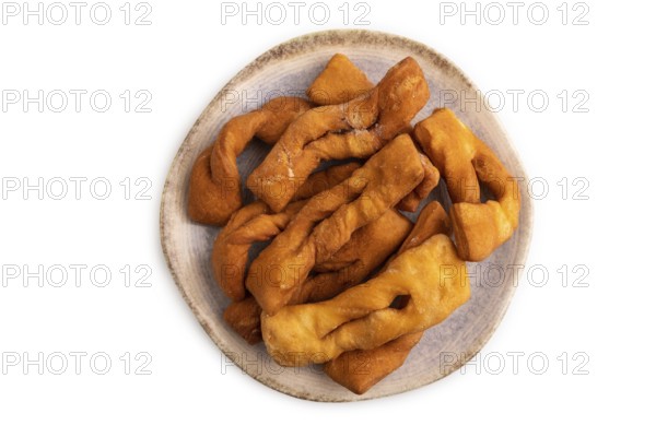 Crunchy biscuit Brushwood cookies sprinkled with powdered sugar isolated on white background, top view, flat lay, close up