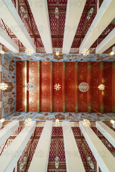 Photo from the frog persective:Ubosot (ordination hall) with columns (Sao) and richly decorated ceiling (Phra Phimarn) and crystal chandeliers, Rattanakosin architecture (Bangkok style), Wat Chana Songkhram, Phra Nakhon, Bangkok, Thailand