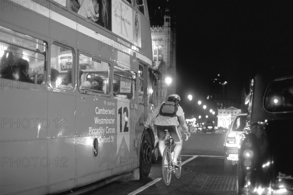 London at night, bus and cyclist on Westminster Bridge, black and white, London, England, Great Britain
