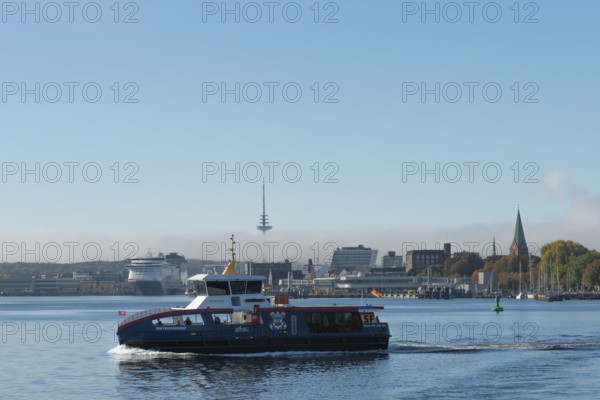 Kiel port, liner Dietrichsdorf on the fjord and Kiel-Oslo ferry on the east shore quay, ferry and crusader of the Color Line, radio tower, tower of St. Nikolai church, Swedish quay, marina, haze bell, Baltic Sea, Schleswig-Holstein, Germany