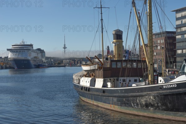 Kiel harbor, Seegarten museum bridge with historic buzzard from 1906, chimney, crane, Kiel-Oslo ferry on the east shore quay, ferry and crusader of the Color Line, radio tower, haze bell, blue sky, sunshine, Kiel Fjord, Baltic Sea, Schleswig-Holstein, Germany