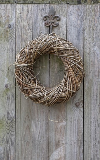 Door wreath made of natural materials on a wooden wall, North Rhine-Westphalia, Germany