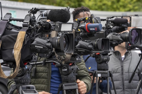 Camera crews, TV teams from various radio stations, television stations, film at a press conference