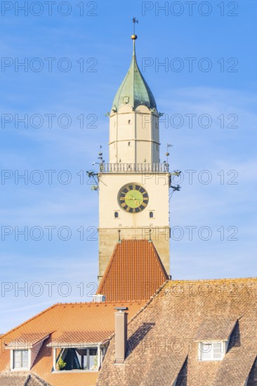 Church tower with clock over red roof tiles under clear blue sky, Überlingen, Lake Constance, Germany