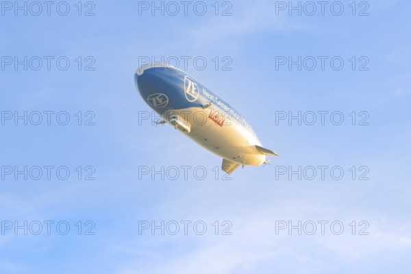 Zeppelin under a clear, cloudless sky, carrying an advertising message, Überlingen, Lake Constance, Germany