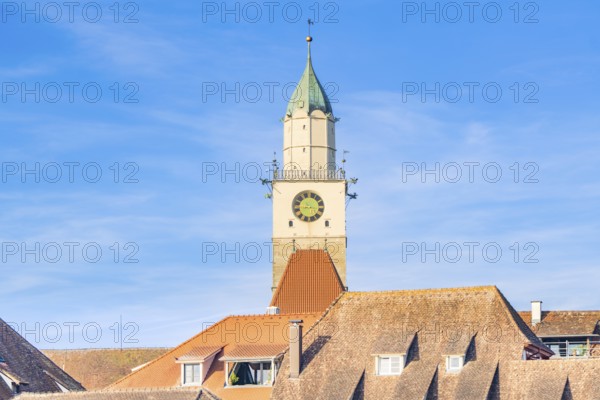 A remarkable church tower with clock over red roof tiles in sunlight, Überlingen, Lake Constance, Germany