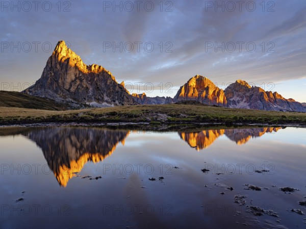 Alpine glow, reflection of the Ra Gusela and Tofane mountains at sunrise, Passo di Giau, Giau Pass, Dolomites, Alps, Belluno province, Veneto region, Italy