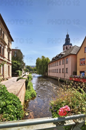 Ettlingen, Germany - August 13th 2025: View from bridge on Alb river in historic city center with buildings