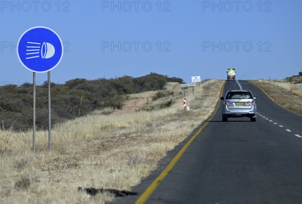 Light requirement sign for overland journeys on the B1 highway between Windhoek and Otjiwarongo, near Otjiwarongo, Otjozondjupa region, Namibia