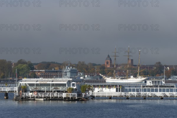 Kiel naval port, district of Wik, sailing school ship Gorch Fock in their home port, supply ship A512 of the German Navy, tower of the garrison church Petrus-Kirche, Seebar Düsternbrook, Schleswig-Holstein, Germany