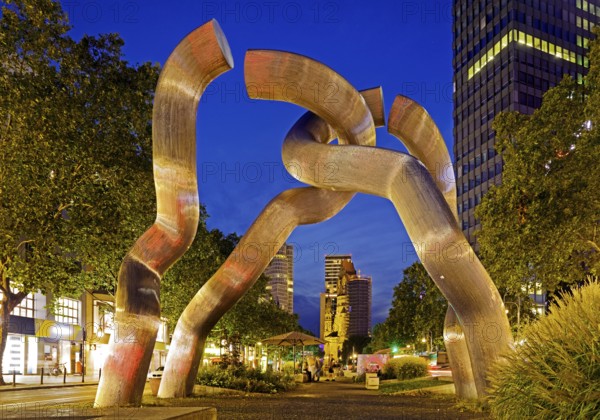 The sculpture entitled Berlin by Brigitte and Martin Matschinsky-Denninghoff with Kaiser Wilhelm Memorial Church in the evening, Charlottenburg, Berlin, Germany